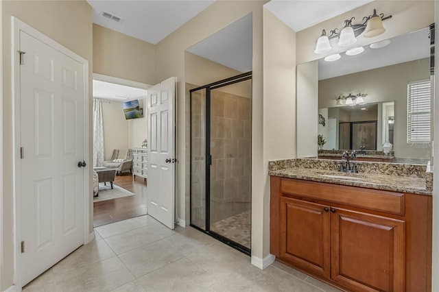 bathroom featuring walk in shower, vanity, and wood-type flooring