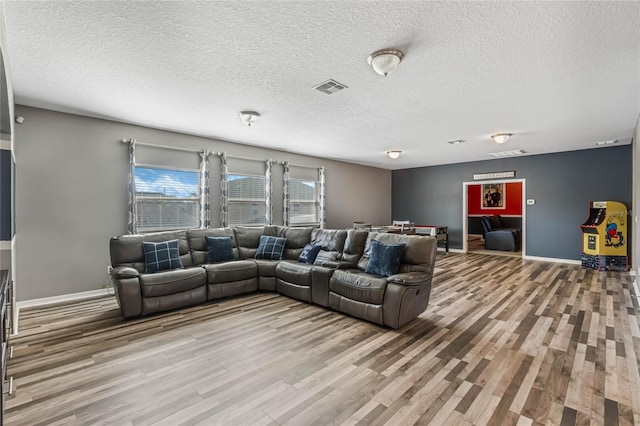 living room featuring hardwood / wood-style flooring and a textured ceiling