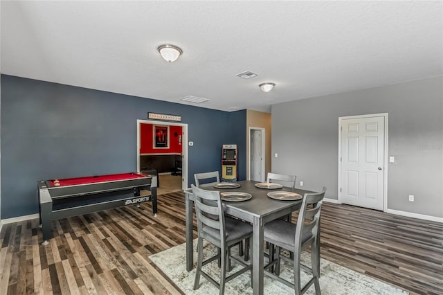 dining area featuring dark hardwood / wood-style floors and a textured ceiling