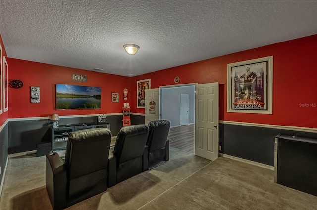 home theater room featuring carpet and a textured ceiling