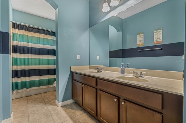 bathroom with tile patterned floors, toilet, vanity, and a shower with curtain