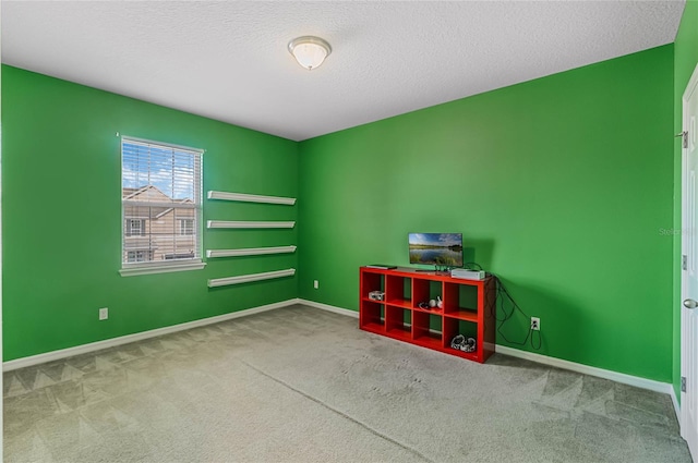 unfurnished room featuring a textured ceiling and carpet flooring