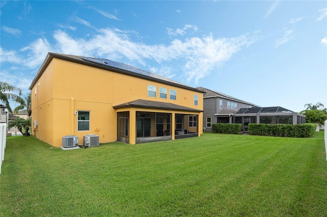 back of house with a yard, a sunroom, and central AC unit