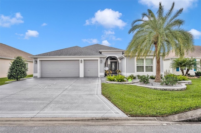 view of front of home with a front yard and a garage