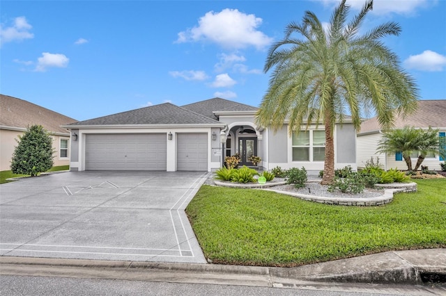 view of front of property with a front yard and a garage