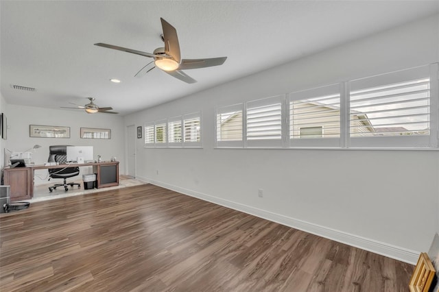 unfurnished office featuring wood-type flooring and ceiling fan