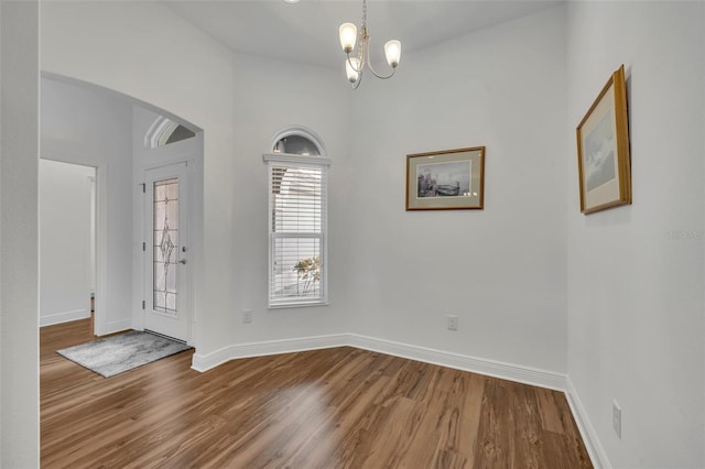 interior space featuring hardwood / wood-style flooring and an inviting chandelier