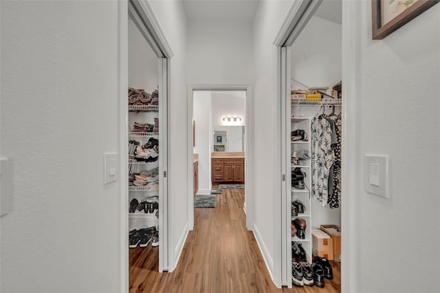 hallway with light hardwood / wood-style floors