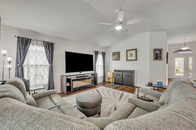 living room featuring lofted ceiling, hardwood / wood-style flooring, and ceiling fan