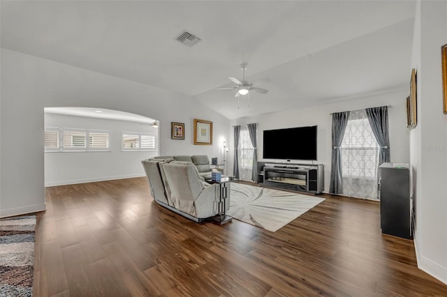 unfurnished living room featuring lofted ceiling, ceiling fan, dark hardwood / wood-style floors, and plenty of natural light