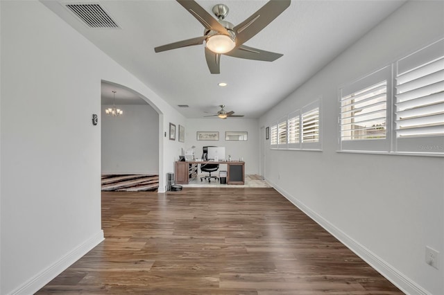 hall with wood-type flooring and an inviting chandelier