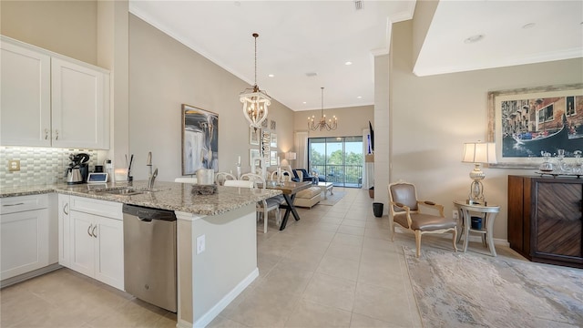 kitchen with tasteful backsplash, dishwasher, kitchen peninsula, hanging light fixtures, and white cabinetry