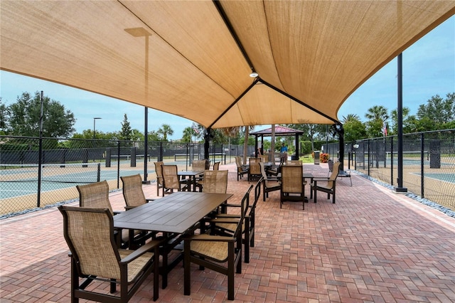 view of patio with a gazebo and tennis court