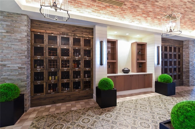 wine room with light floors, a raised ceiling, and visible vents