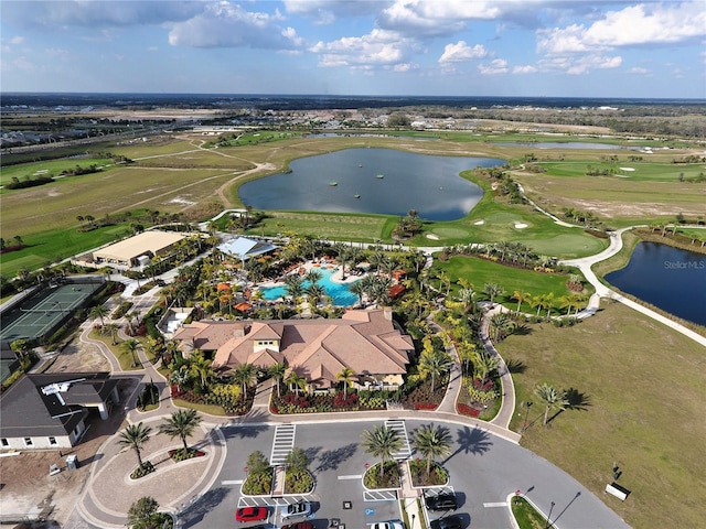 drone / aerial view with a water view and golf course view