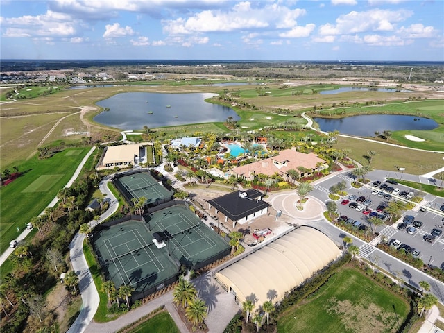 bird's eye view with a water view and view of golf course