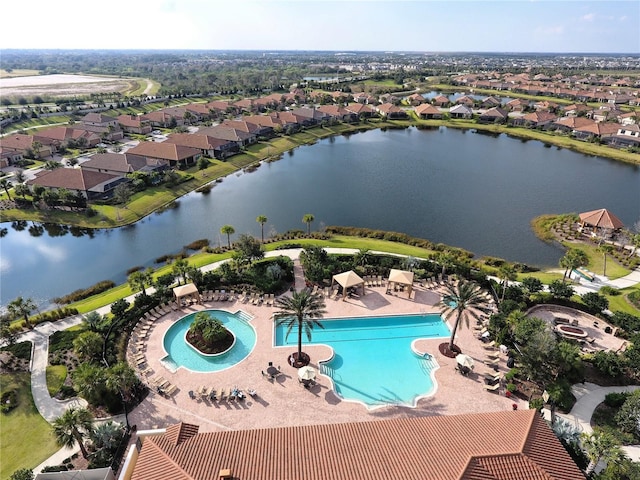 drone / aerial view featuring a residential view and a water view