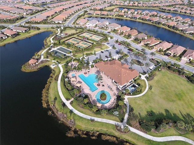 drone / aerial view featuring a water view and a residential view