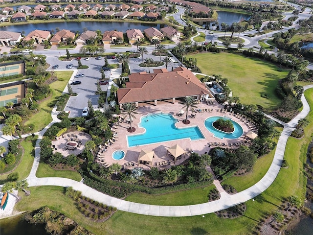 drone / aerial view featuring a residential view and a water view
