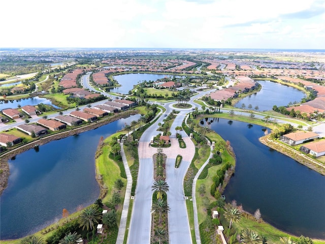 drone / aerial view with a residential view and a water view