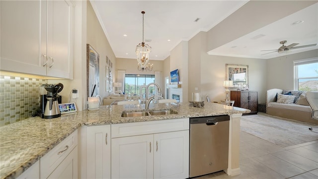 kitchen featuring dishwasher, sink, white cabinets, and light stone counters