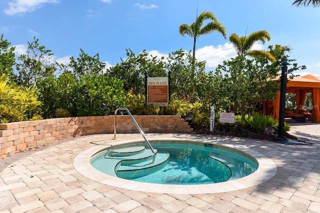 view of swimming pool with a community hot tub