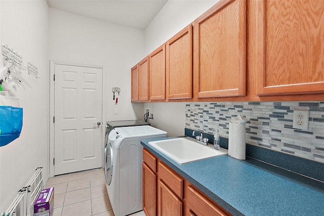 laundry room featuring cabinets, washer hookup, sink, and light tile patterned floors