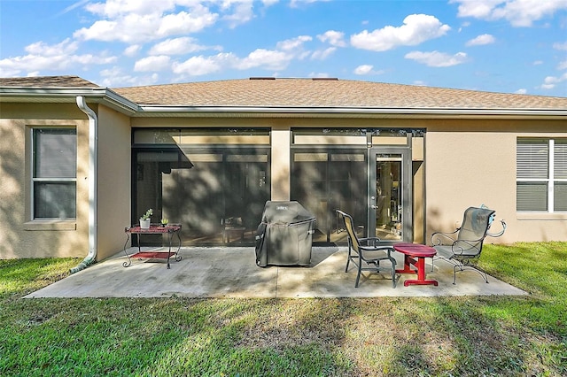 rear view of house featuring a yard and a patio area