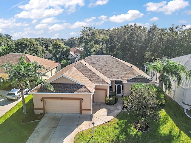 view of front of home with a garage and a front lawn