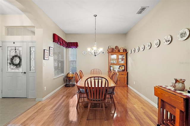 dining area featuring a chandelier and light hardwood / wood-style flooring