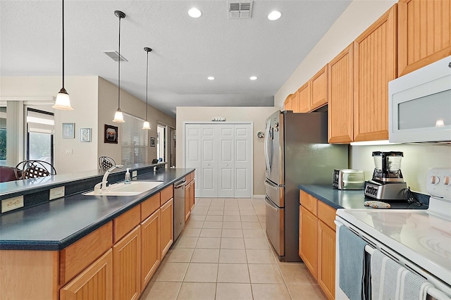 kitchen with sink, decorative light fixtures, a textured ceiling, light tile patterned floors, and stainless steel appliances