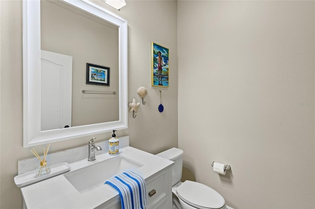 bathroom with toilet and vanity