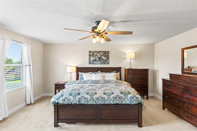 carpeted bedroom with a textured ceiling and ceiling fan