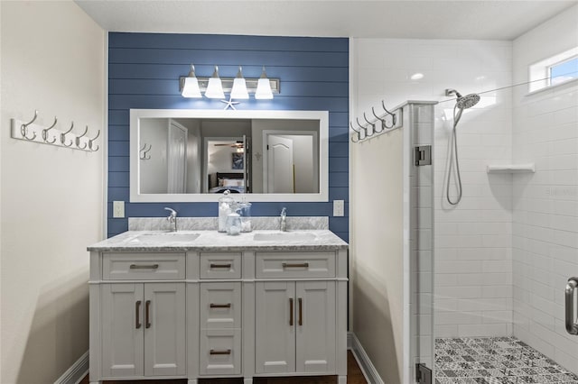 bathroom with a shower with door and vanity