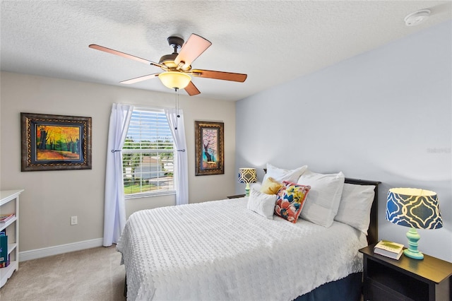 carpeted bedroom with a textured ceiling and ceiling fan