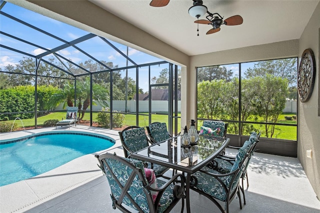 view of swimming pool featuring a yard, a lanai, ceiling fan, and a patio area