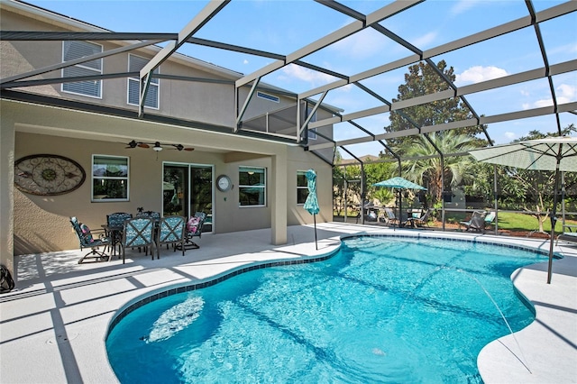 view of swimming pool featuring ceiling fan, a patio area, and glass enclosure