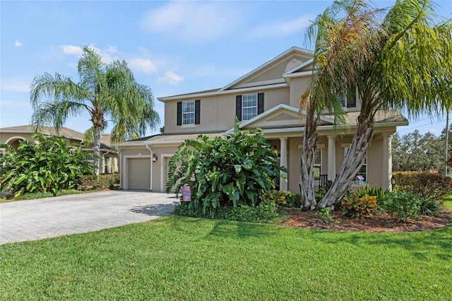 view of front facade featuring a front yard and a garage