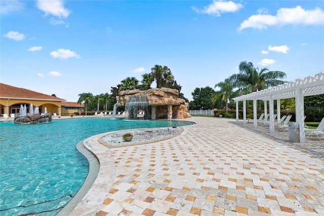 view of pool featuring a patio area, pool water feature, and a pergola