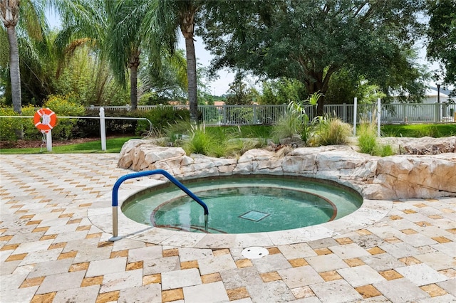 view of pool featuring a patio area and an in ground hot tub