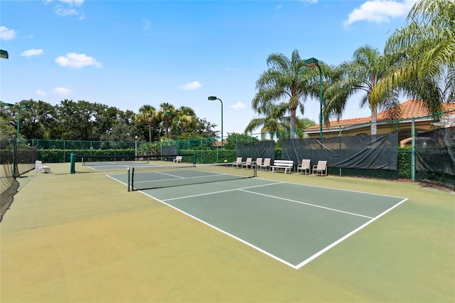 view of tennis court with basketball hoop