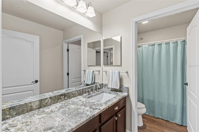 bathroom featuring hardwood / wood-style floors, vanity, and toilet