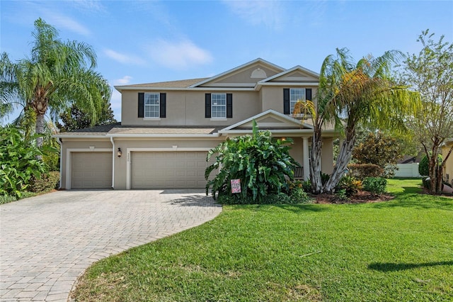 view of front of home with a front yard and a garage