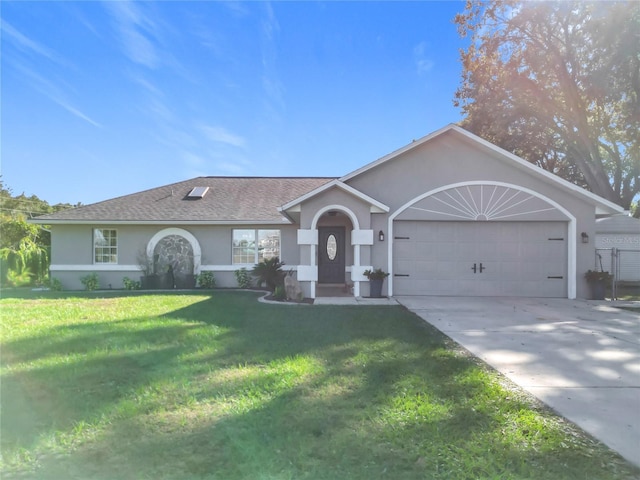 ranch-style home featuring a garage and a front yard