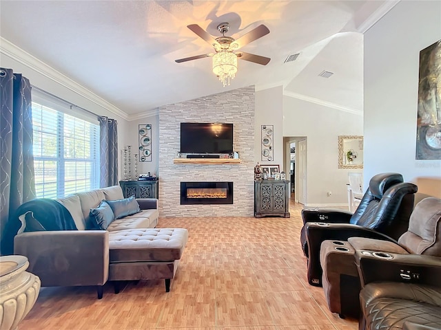 living room with ceiling fan, ornamental molding, a stone fireplace, and vaulted ceiling