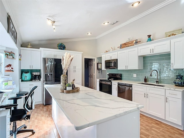 kitchen featuring stainless steel appliances, backsplash, vaulted ceiling, white cabinets, and sink