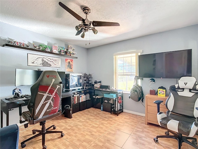 home office with ceiling fan and a textured ceiling