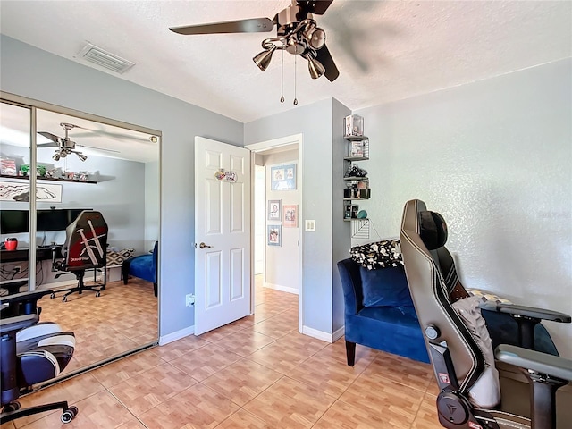 office with a textured ceiling and ceiling fan