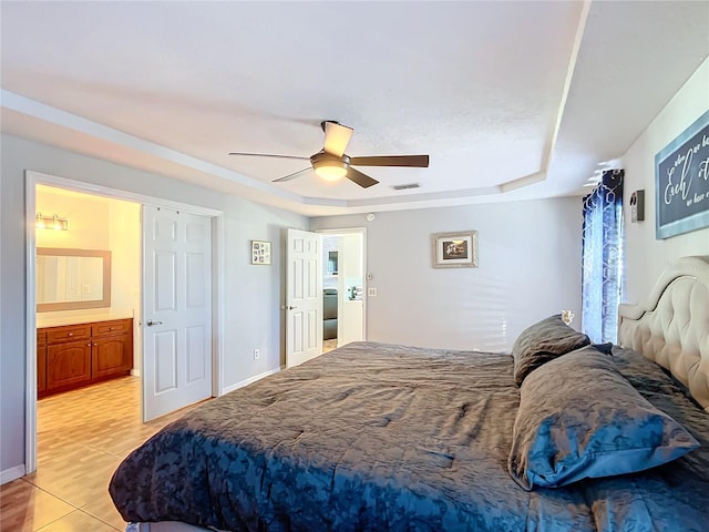 bedroom with ceiling fan and a raised ceiling