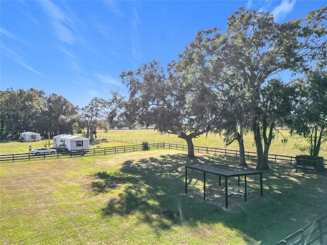 view of yard with a rural view and an outdoor structure